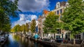 Historic Houses, parked Cars and Bikes  along a canal in the historic center of Amsterdam Royalty Free Stock Photo