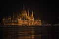 Historic Hungarian parliament building in Budapest at night. The river Danube and reflection of the building in Royalty Free Stock Photo