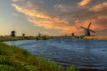 Historic Kinderdijk village with ancient windmills at sunset Netherlands Holland rural landscape popular destination Royalty Free Stock Photo