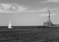 Historic Lighthouse of Old Port of Chania with a Sailing Boat, Crete Island, Greece in Monochrome Royalty Free Stock Photo