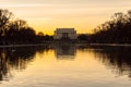 Historic Lincoln Memorial and Reflecting Pool at Sunset in Washington DC, USA. Bare Tree Silhouettes and Beautiful Sky Colors