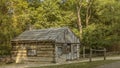 Historic log cabinn with a horse hitching post