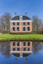 Historic mansion Ennemaborg with reflection in the pond in Midwolda