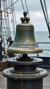 Historic maritime ship bell on deck against ocean background Royalty Free Stock Photo