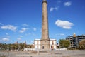 Historic Maspalomas Lighthouse at coastline under blue sky on a sunny day