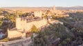 Historic medieval Castle in Segovia, Spain. Drone aerial view with sunset light of spanish stronghold in old town with monument Royalty Free Stock Photo