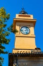 Historic medieval clock tower at Place du 24 Aout square in old town quarter of perfumery city of Grasse in France