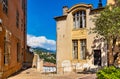 Historic medieval clock tower and tenement houses at Place du 24 Aout square in old town of perfumery city of Grasse in France