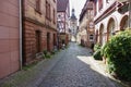 Historic medieval old town with half-timbered houses and cobblestone pavement and city gate with archway Royalty Free Stock Photo