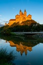 Historic Melk Abbey in warm evening light with reflections in the calm Danube River