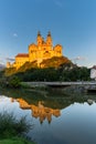 Historic Melk Abbey in warm evening light with reflections in the calm Danube River