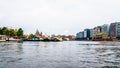 Historic and modern buildings along the busy harbor of the city of Amsterdam