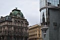 Historic and modern neighbors in the same city of Vienna, two buildings, in the foreground, the modern one, on the left two histor