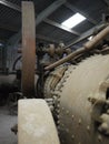 Historic old metal iron steam engine close up in an old barn shed