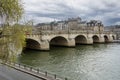 Historic Paris bridge over the river Sena on a cloudy day Royalty Free Stock Photo