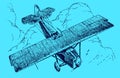 Historic plane in top view flying over large cumulus clouds on a blue background Royalty Free Stock Photo