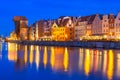 Historic port crane and ship over Motlawa river in Gdansk at night Royalty Free Stock Photo