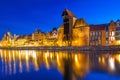 Historic port crane and ship over Motlawa river in Gdansk at night Royalty Free Stock Photo