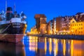 Historic port crane and ship over Motlawa river Royalty Free Stock Photo