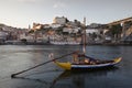 Historic port wine boat in front of the city Porto with river Douro during sunset, Portugal Royalty Free Stock Photo