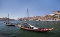 Historic port wine boats in front of the city Porto with river Douro during sunny day, Portugal