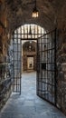 Historic Prison Corridor with Stone Arches and Iron-Barred Doors Royalty Free Stock Photo
