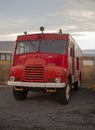 Historic red fire engine in a parking lot in Reykjavik, Iceland. Retro car in perfect condition. Vertical photo.