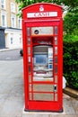 Historic red phone box as cash machine, London, UK Royalty Free Stock Photo