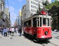 A historic red tram in front of the Galatasaray High School at the southern end of istiklal Avenue