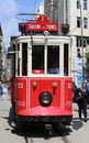 A historic red tram in front of the Galatasaray High School at the southern end of istiklal Avenue