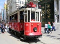 A historic red tram in front of the Galatasaray High School at the southern end of istiklal Avenue