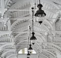 Historic restored white painted wooden ceiling with old-fashioned lamps on the ceiling of a portico in Karlovy Vary, Czech