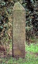 Historic road distance marker made of carved sandstone, indicating the distance in miles