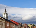 Historic Roros Kirke steeple rises above traditional vibrant wooden Norwegian houses Royalty Free Stock Photo