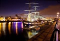 Historic sail ship docked in the city at night