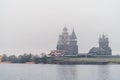 Historic site of wooden churches of Kizhi Island, Republic of Karelia, Russia. Onega lake autumn foggy landscape Royalty Free Stock Photo