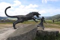 Historic statue of farm girl fighting giant wolf the Beast of Geveaudan in France.