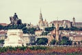 Historic statue, Matthias church, Fishermans bastion and Calvinist church in Budapest city Royalty Free Stock Photo