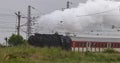 Historic steam locomotive with passenger wagons on rail tracks Royalty Free Stock Photo