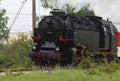 Historic steam locomotive with passenger wagons on rail tracks Royalty Free Stock Photo