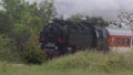 Historic steam locomotive with passenger wagons on rail tracks Royalty Free Stock Photo