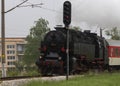 Historic steam locomotive with passenger wagons on rail tracks Royalty Free Stock Photo