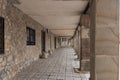 Historic stone colonnade with arched walkway and rustic architecture in a quiet village setting Royalty Free Stock Photo