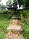 Historic colonial stone house entry sidewalk steps and garden USA Royalty Free Stock Photo