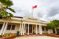 Historic stone National Treasury building, the centre of Nukualofa city. Red white cross tongan flag flying, Tongatapu, Tonga.