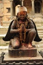 A historic stone statue of a praying female in Patan, a suburb of Kathmandu, Nepal