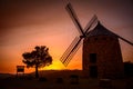 Historic stone windmill in the countryside during an orange sunset in rural Alcublas,Spain