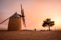 Historic stone windmill in the countryside during an orange sunset in rural Alcublas,Spain
