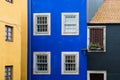 Old brightly colored buildings with stucco painted in yellow, blue, and black hues in Porto, Portugal