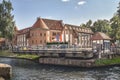 Historic Swing Bridge on Luczanski Canal and medieval Teutonic Knights castle in the background, Gizycko, Masuria, Poland. Royalty Free Stock Photo